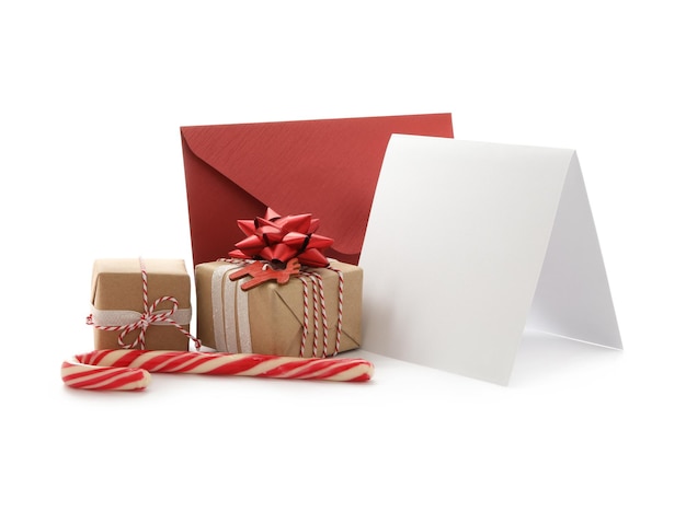 Composition with blank greeting card and Christmas gifts on white background space for text