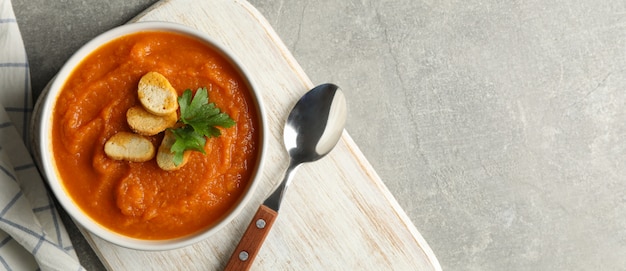 Composition with bowl of pumpkin puree with croutons