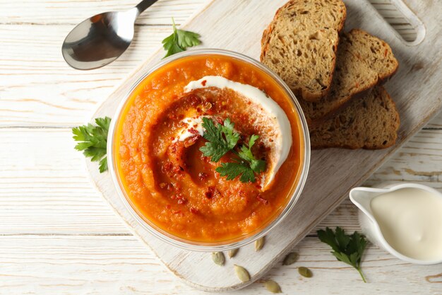 Composition with bowl of pumpkin soup