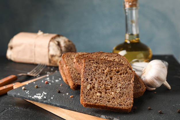 Composition with bread on cutting board, closeup and space for text