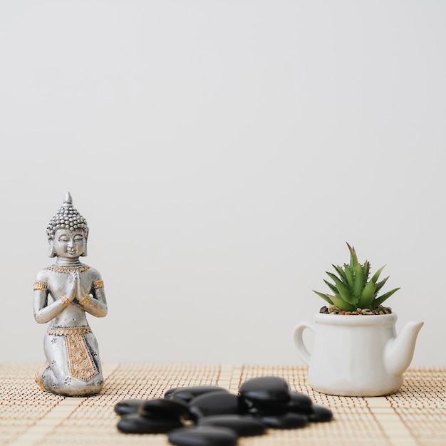 Photo composition with buddha figure and pot