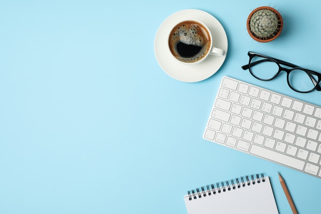 Composition with business accessories on blue.