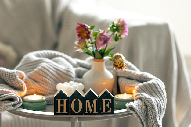 Composition with candles flowers and decorative word home