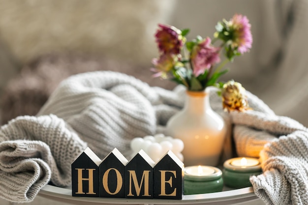 composition with candles flowers and decorative word home
