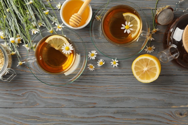 Composition with chamomile tea on gray wood