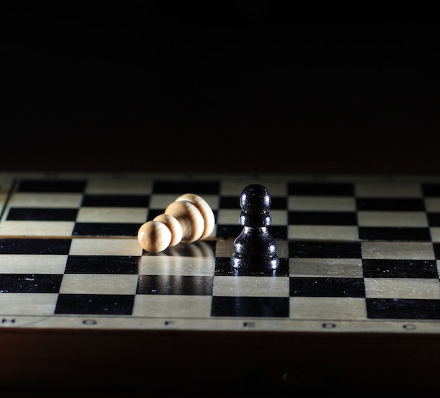 Composition with chessmen on glossy chessboard