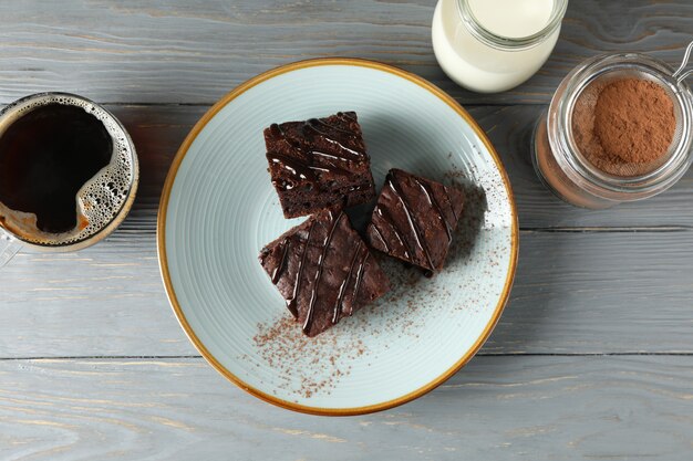 Composition with chocolate cake slices on wooden background, top view