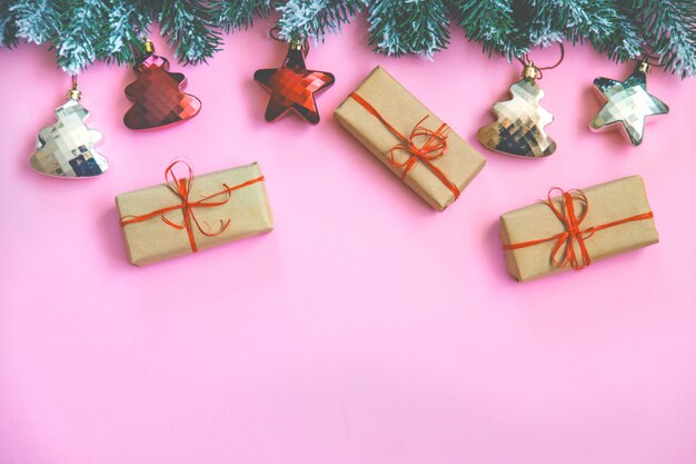 Composition with Christmas decoration on pink background for greeting card