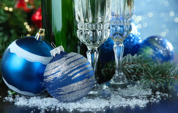 Composition with Christmas decorations and two champagne glasses, on bright background