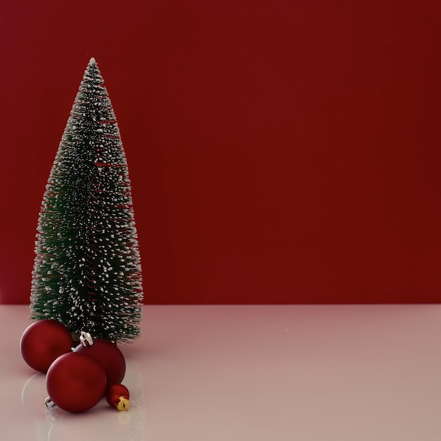 Composition with Christmas gift box with Christmas tree decoration on red background