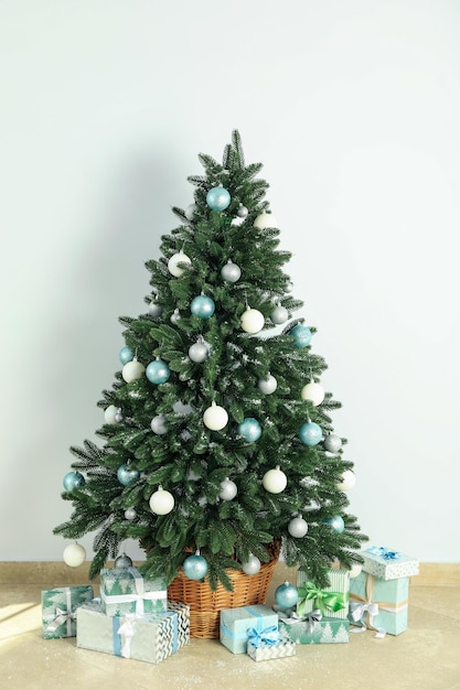 Composition with Christmas tree and gifts on background floor