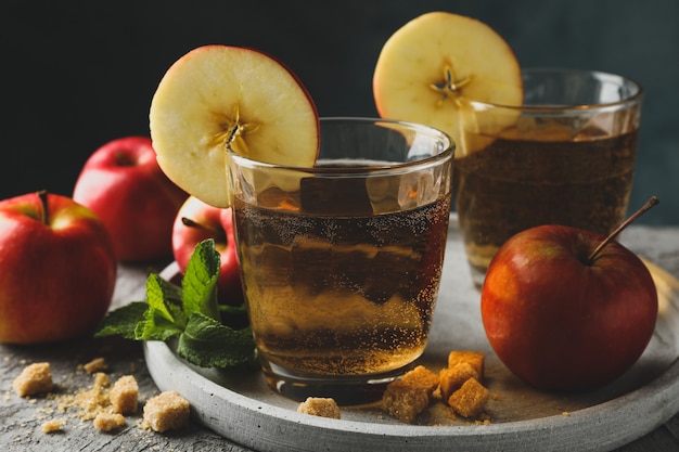 Composition with cider, sugar and apples on gray table