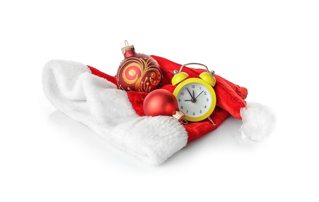 Composition with clock, Santa hat and festive decor on white background. Christmas countdown concept