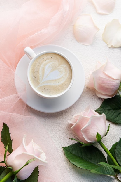 Composition with coffee and pink rose flowers