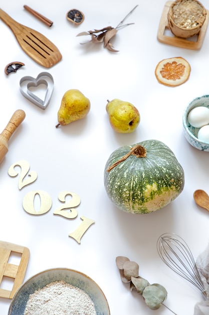 Composition with cooking products and kitchen accessories on a white table. The concept of cooking a festive meal.