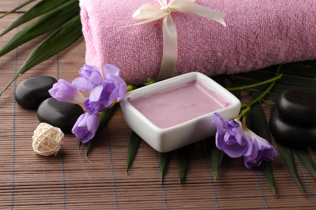 Composition with cosmetic clay for spa treatments on bamboo background