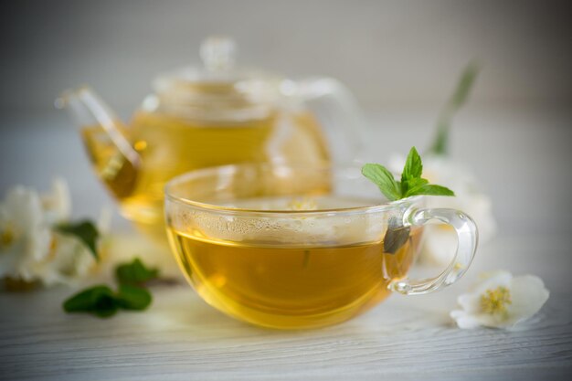 Composition with cup of jasmine tea and flowers