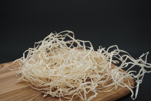 Composition with decorative straw, on a wooden background.