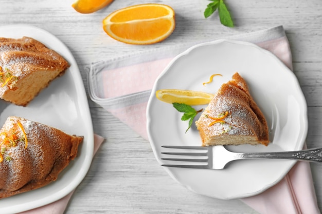 Composition with delicious citrus cake on wooden table