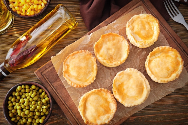 Composition with delicious meat mini pies on table