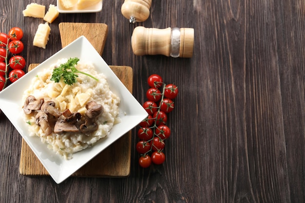 Composition with delicious risotto on wooden background
