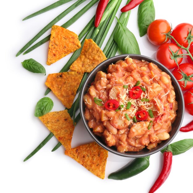 Composition with delicious turkey chili and vegetables on white background