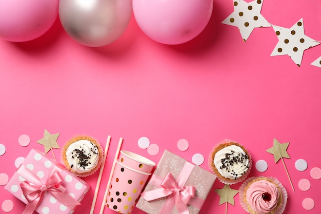 Composition with different birthday accessories on pink background, space for text