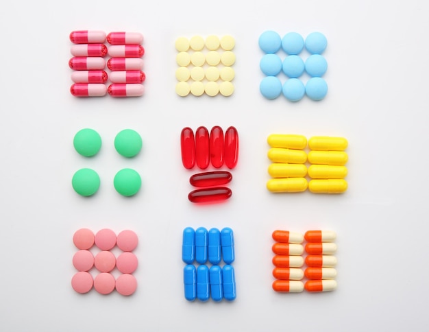 Композиция с различными красочными таблетками на белом фоне