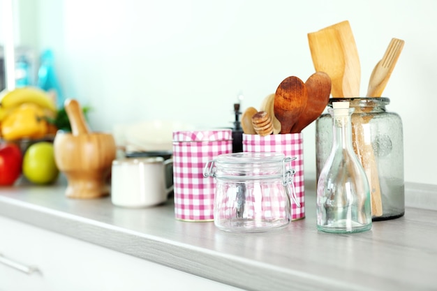 Composition with different utensils on wooden wooden table in kitchen