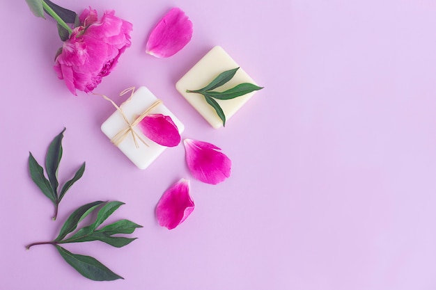 Composition with flowers, petals of peony, natural organic soap. Beauty, skin care concept. Flat lay, top view