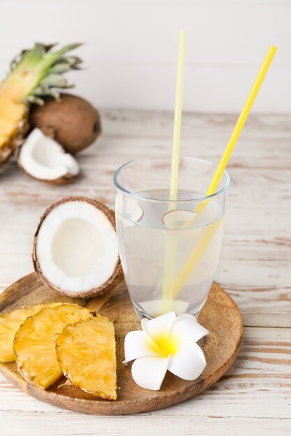 Composition with fresh coconut water and fruits on table