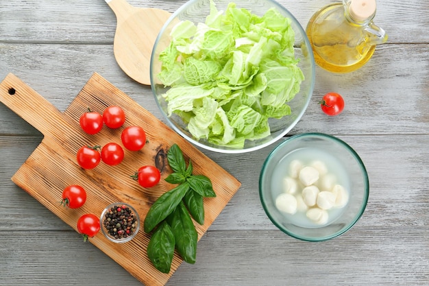 Composition with fresh green cabbage leaves on wooden background