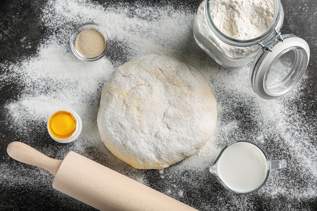 Composition with fresh raw dough on table