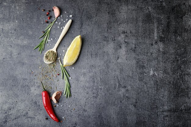 Composition with fresh rosemary and spices on grey background