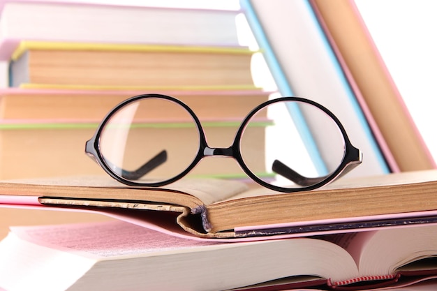 Composition with glasses and books isolated on white