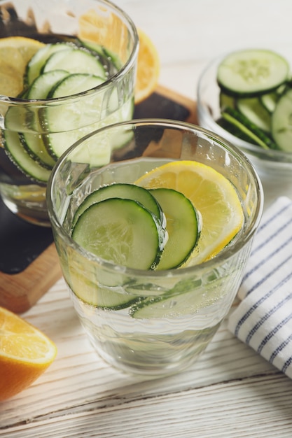 Composition with glasses of cucumber water on wooden surface