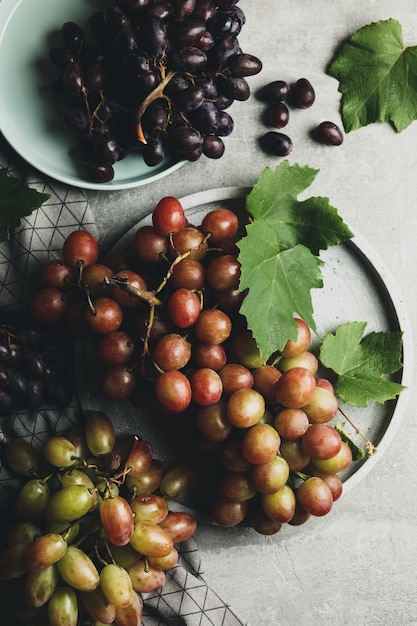 Composition with grape and towel on gray