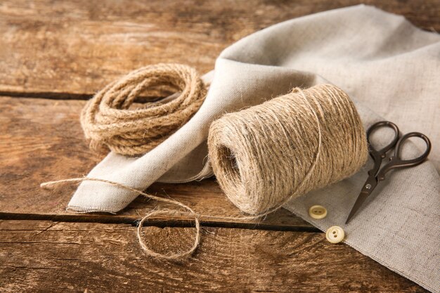 Composition with hemp twine and rope on wooden background