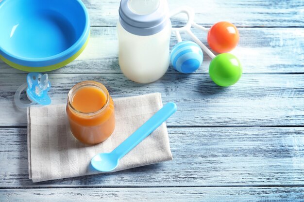 Composition with jar of healthy baby food on wooden table