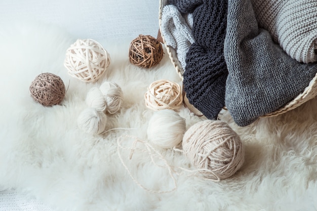 composition with knitted sweaters and a ball of thread