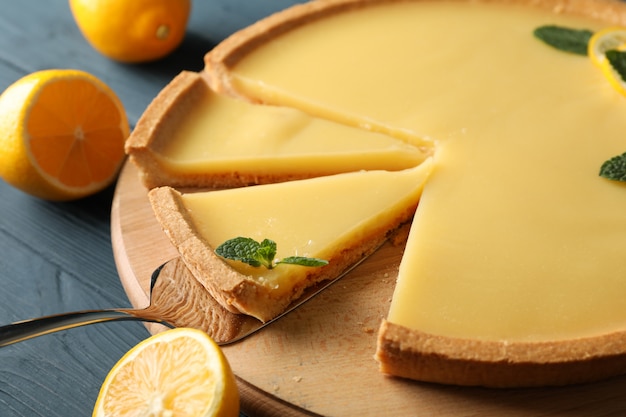 Composition with lemon tart on wooden background, close up