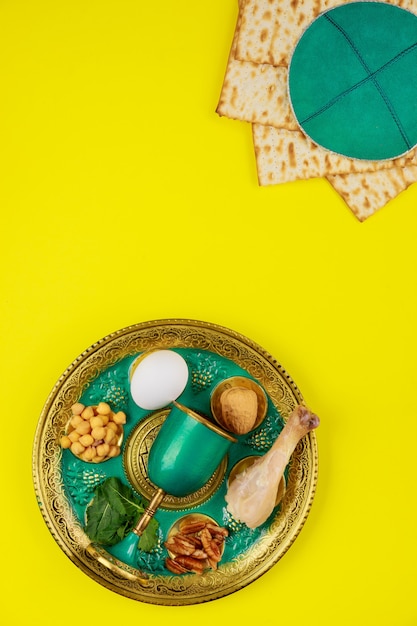 Photo composition with matzo bread, kippah and seder plate. top view. passover jewish holiday.