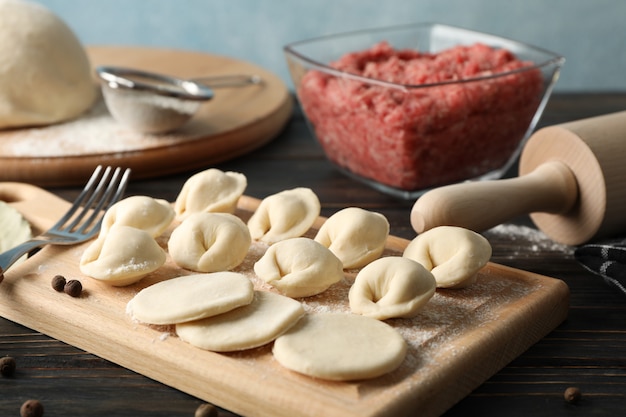 Composition with minced meat and dumplings on wooden, close up