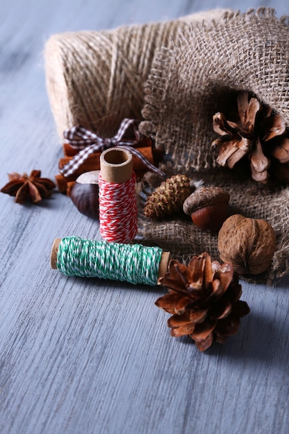 Composition with natural bump, thread, cinnamon sticks on wooden surface