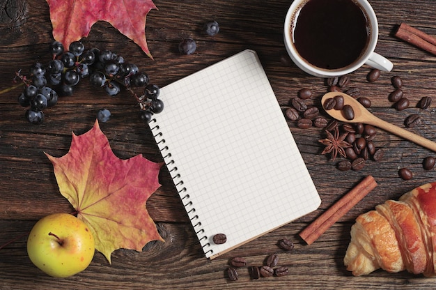 Composition with notepad, coffee and different fruits on dark wooden table, top view