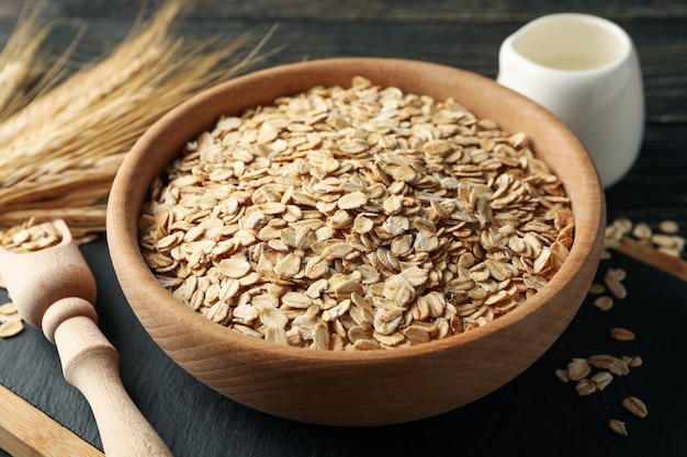 Composition with oatmeal flakes and milk on wooden