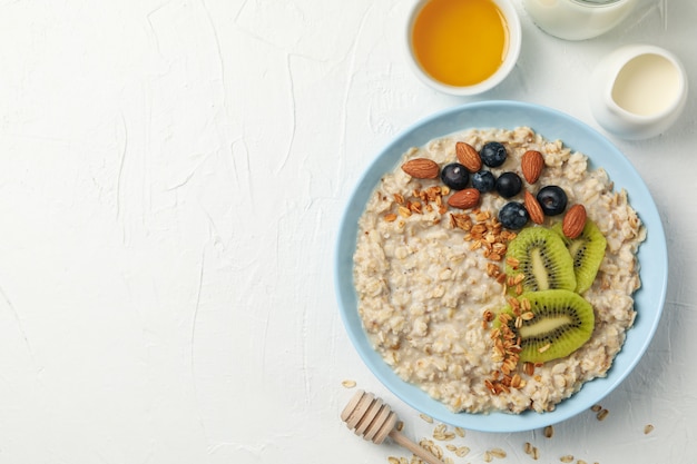 Composition with oatmeal with fruits on white