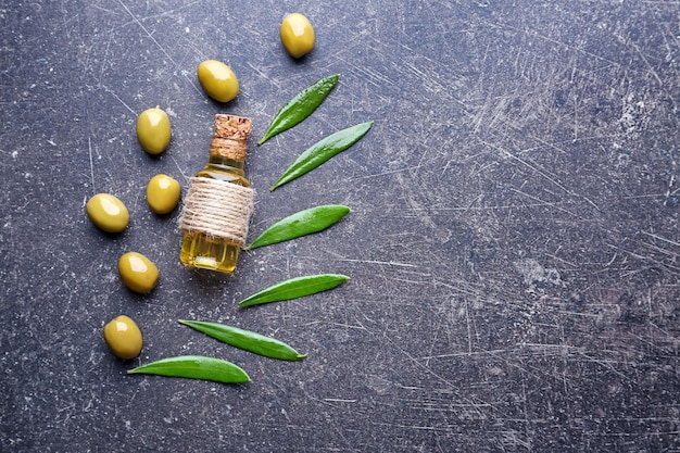 Composition with olive oil on grey background