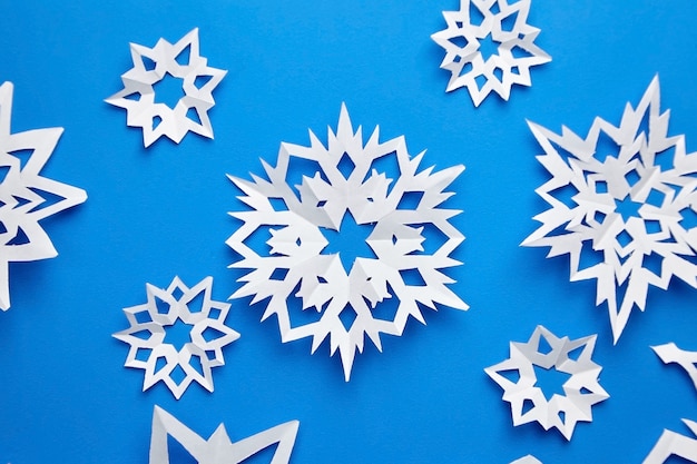 Composition with paper snowflakes on blue