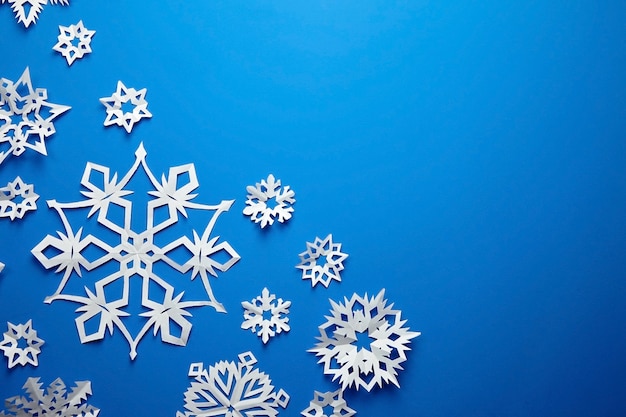 Composition with paper snowflakes on blue